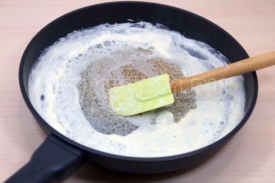 В сковороду влить небольшими порциями 200 миллилитров сливок и после закипания снять пенки со сливок в отдельную миску.