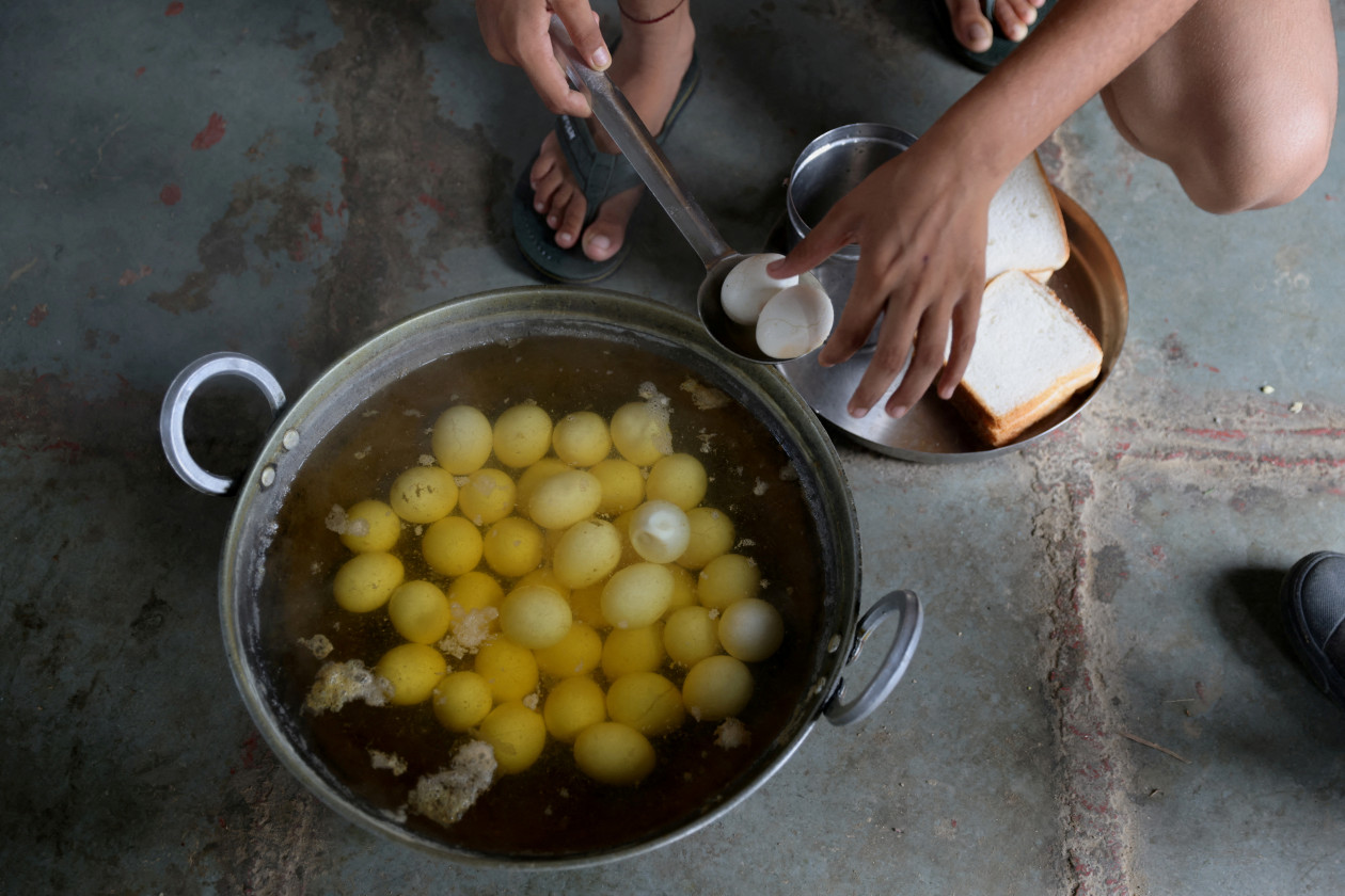 13-летняя Анджали, 15-летняя Найтик Рана и 16-летняя Свати Бервал готовят себе завтрак из вареных яиц - Фото: Анушри Фаднавис/Reuters
